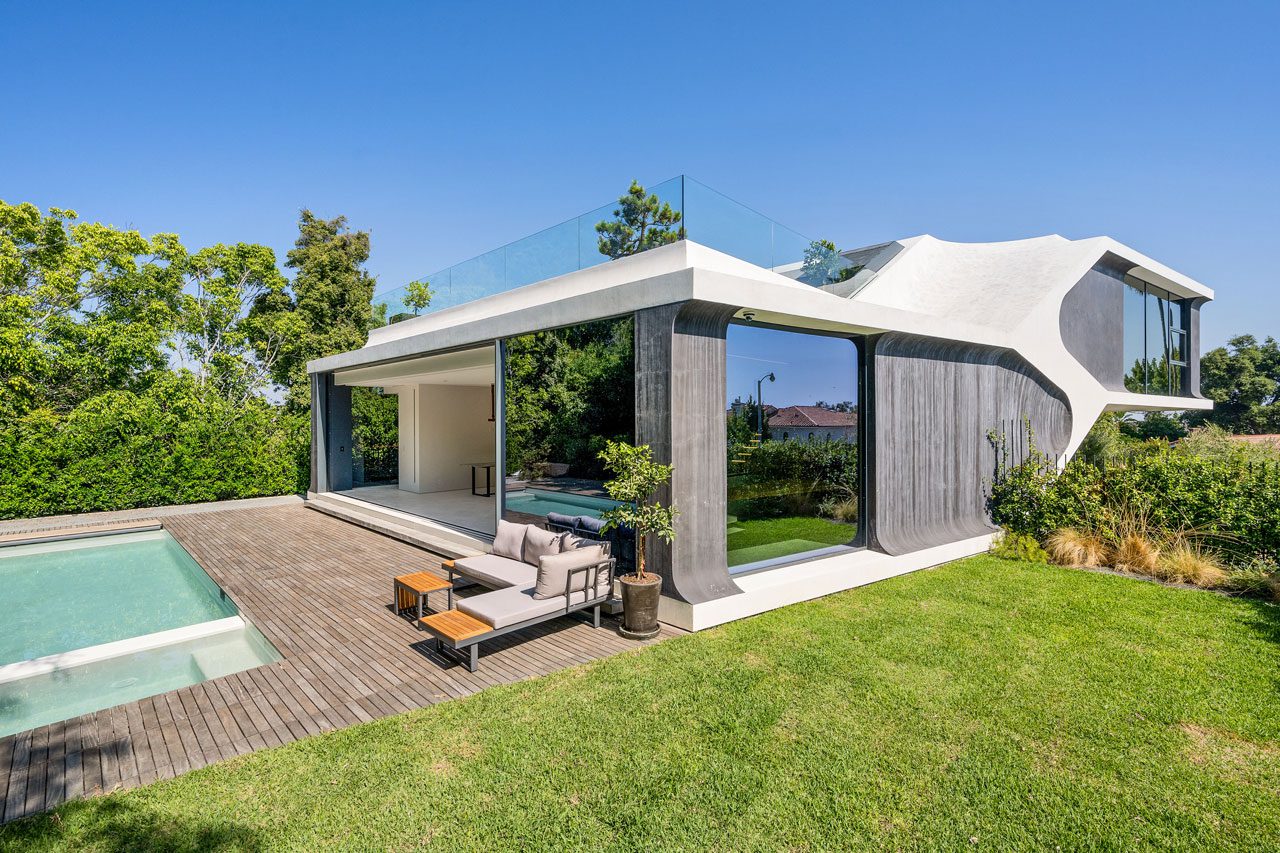 The view of the backyard with pool and loungers